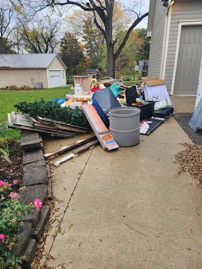 Dumpster being loaded with debris for Roofing Dumpster Rental in Charleston